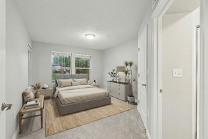 Bedroom with light colored carpet and baseboards