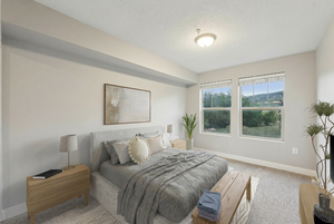 Carpeted bedroom featuring baseboards and a textured ceiling