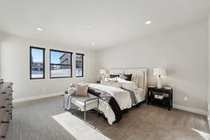 Carpeted bedroom with baseboards and recessed lighting