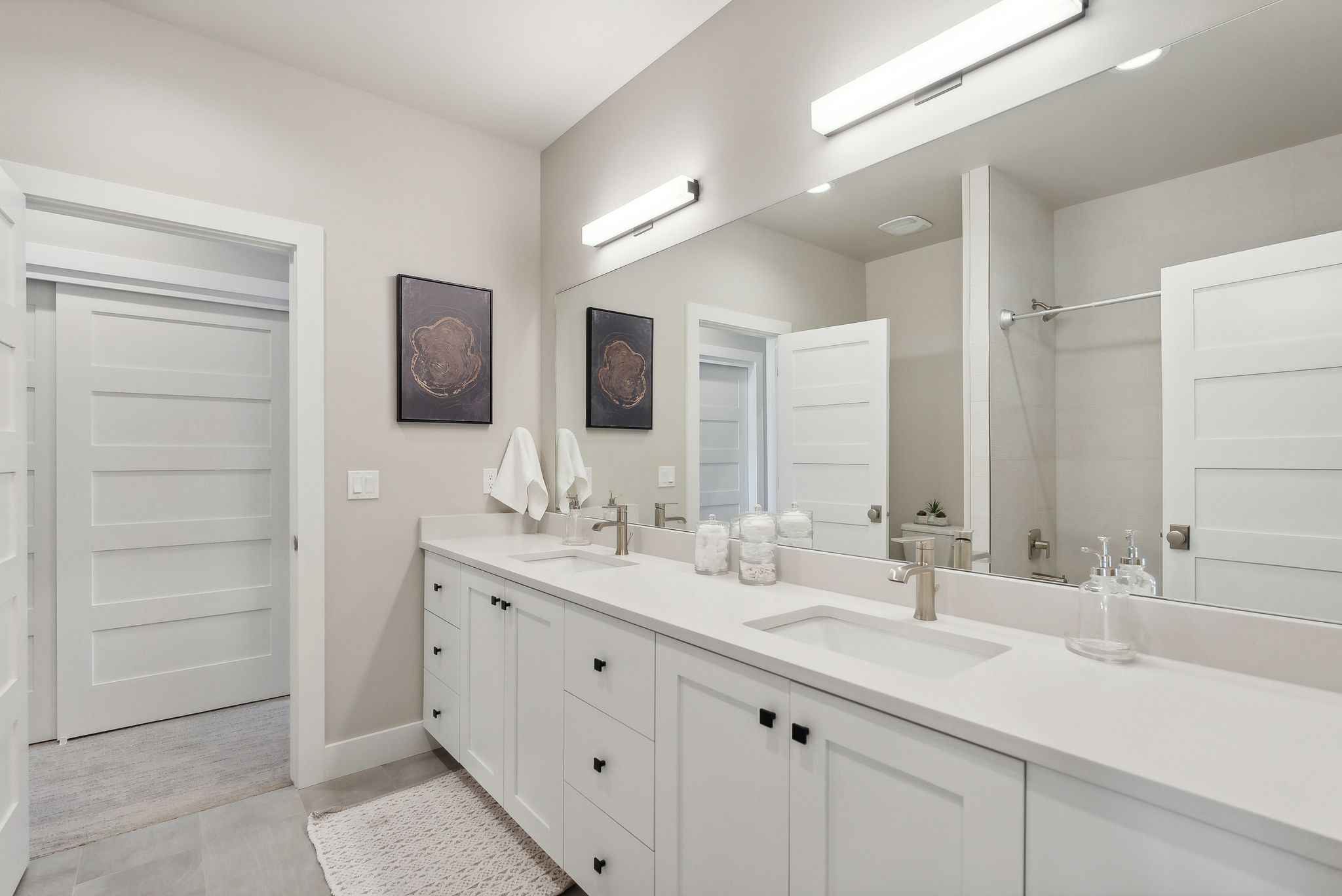Bathroom featuring double vanity and a shower