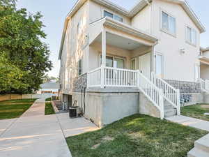 Covered porch front entrance, with community side yard.