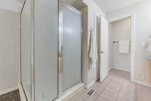 Primary bedroom with stall shower w/ entrance to water closet and primary closet