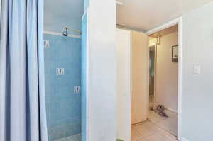 Bathroom with a stall shower and tile patterned flooring