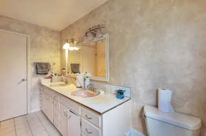 Bathroom with tile patterned floors and double vanity