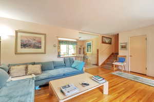 Living room featuring stairway and light wood-type flooring
