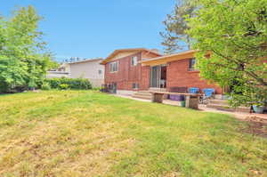 Rear view of property featuring brick siding