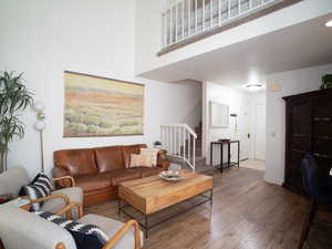 Living room featuring stairs and wood-type flooring
