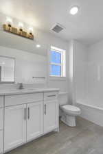 Full bath featuring vanity and bathing tub / shower combination