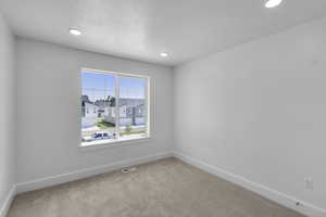 Bedroom with carpet floors and recessed lighting