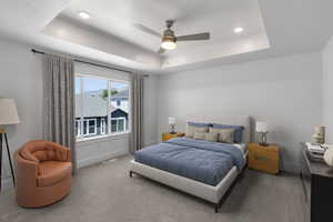 Primary bedroom featuring a tray ceiling, recessed lighting, and ceiling fan
