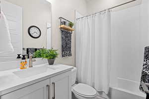 Bathroom with vanity and shower / tub combo