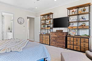 Bedroom with crown molding, recessed lighting, and carpet