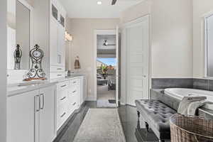 Bathroom featuring ceiling fan, double vanity, a bath, and recessed lighting