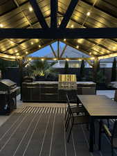 View of patio with area for grilling, outdoor dining space, and a gazebo