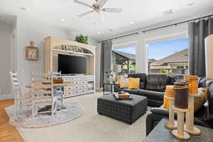 Living area with a ceiling fan and recessed lighting