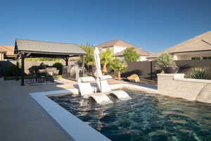 Fenced backyard with a gazebo and a patio area