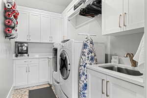 Laundry area featuring cabinet space and washer and clothes dryer
