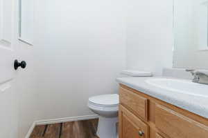 Bathroom featuring vanity and dark wood-style floors