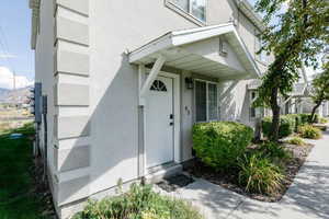 Doorway to property with stucco siding