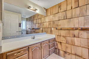 Bathroom featuring vanity and a textured ceiling