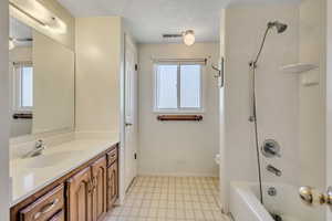 Full bath featuring vanity, healthy amount of natural light, and shower / bathtub combination