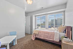 Carpeted bedroom featuring baseboards