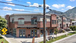 View of front of house featuring french doors, brick siding, and a mountain view