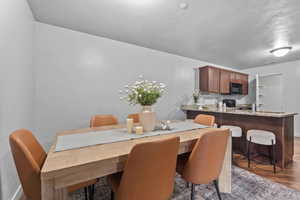 Dining area with wood finished floors and baseboards