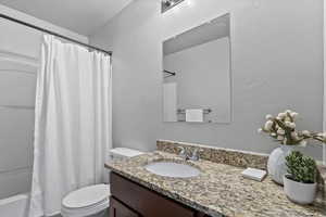 Full bathroom with vanity and shower / tub combo with curtain