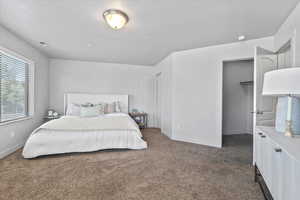 Bedroom featuring carpet flooring and baseboards