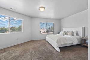 Carpeted bedroom featuring baseboards