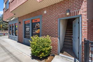 Doorway to property with brick siding