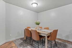 Dining space with baseboards and wood finished floors