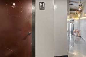 Hallway featuring a textured wall