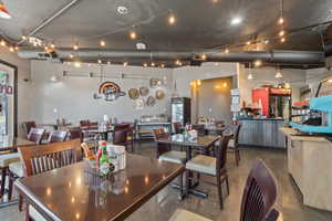 Dining area featuring finished concrete floors and track lighting