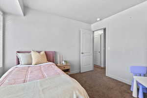 Carpeted bedroom featuring baseboards