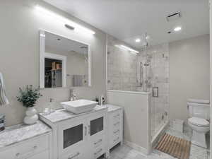 Full bathroom featuring vanity, a shower stall, marble finish floors, a spacious closet, and recessed lighting