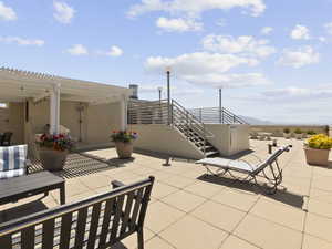 View of patio / terrace on the roof featuring a pergola and a mountain view