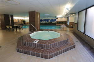 View of swimming pool with a hot tub inside between the north and south buildings