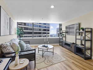 Living room featuring wood finished floors and recessed lighting