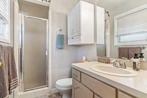 Bathroom with a stall shower and vanity