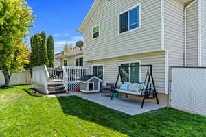 Rear view of house with a wooden deck, a patio, and an outdoor hangout area