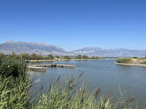 Water view featuring a mountainous background and a floating dock/Marina