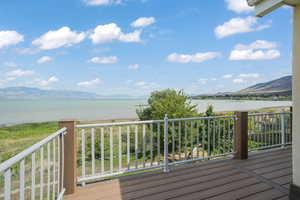 Wooden terrace featuring a water and mountain view