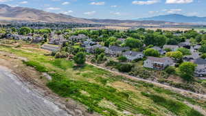 Aerial view of residential area featuring mountains and lake