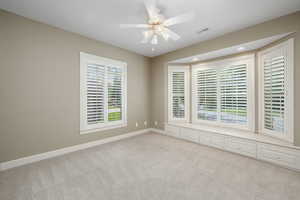 Carpeted empty room with ceiling fan and recessed lighting