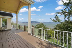 Wooden deck with a water and mountain view