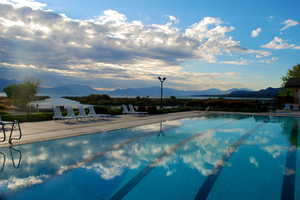 Community pool with a mountain view and a patio