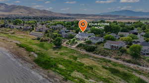 Aerial perspective of suburban area with a mountainous and lake background