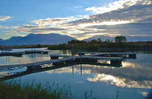 Dock/Marina area featuring a water and mountain view